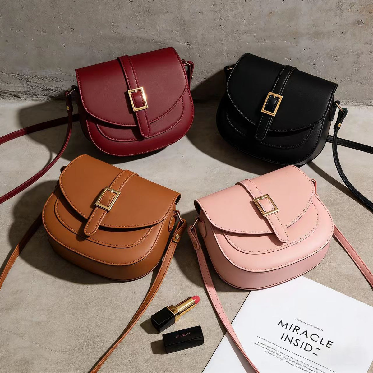 Simple metal-buckle flap crossbody saddle bag with an adjustable shoulder strap.